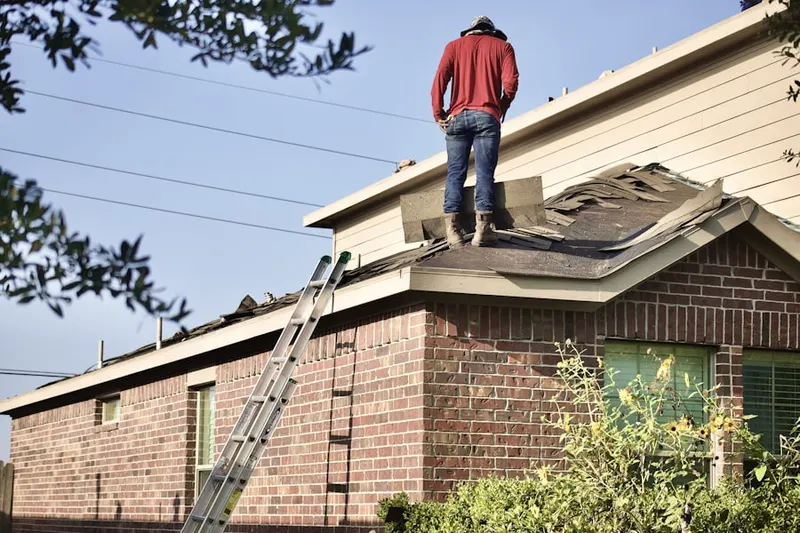 Professional roofer working on a residential roof in Warrenton